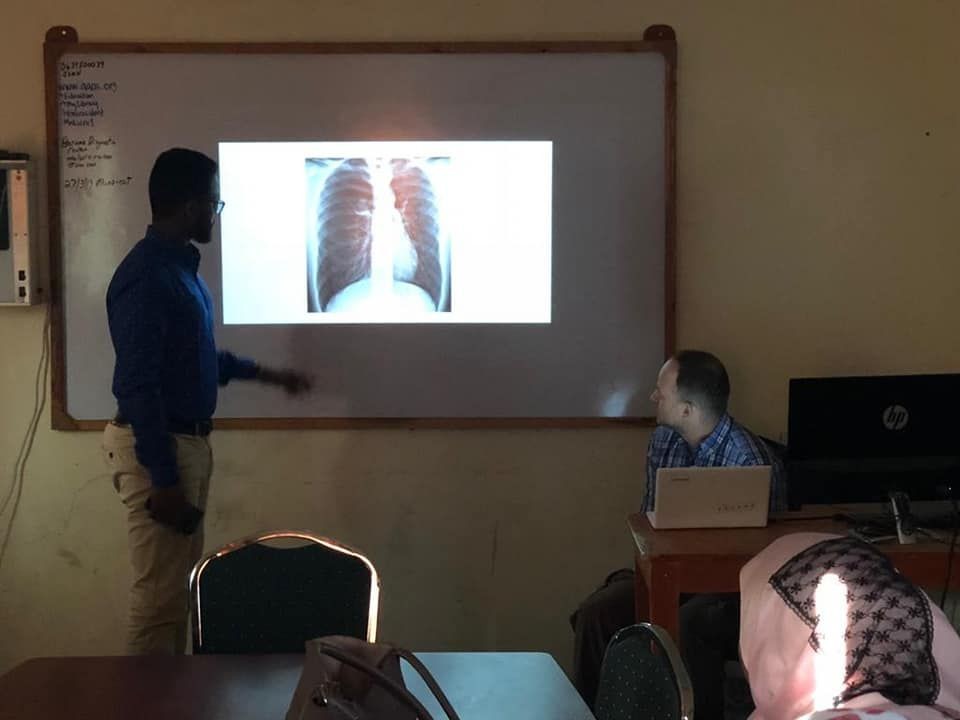 a doctor reading an Xray film under supervisor