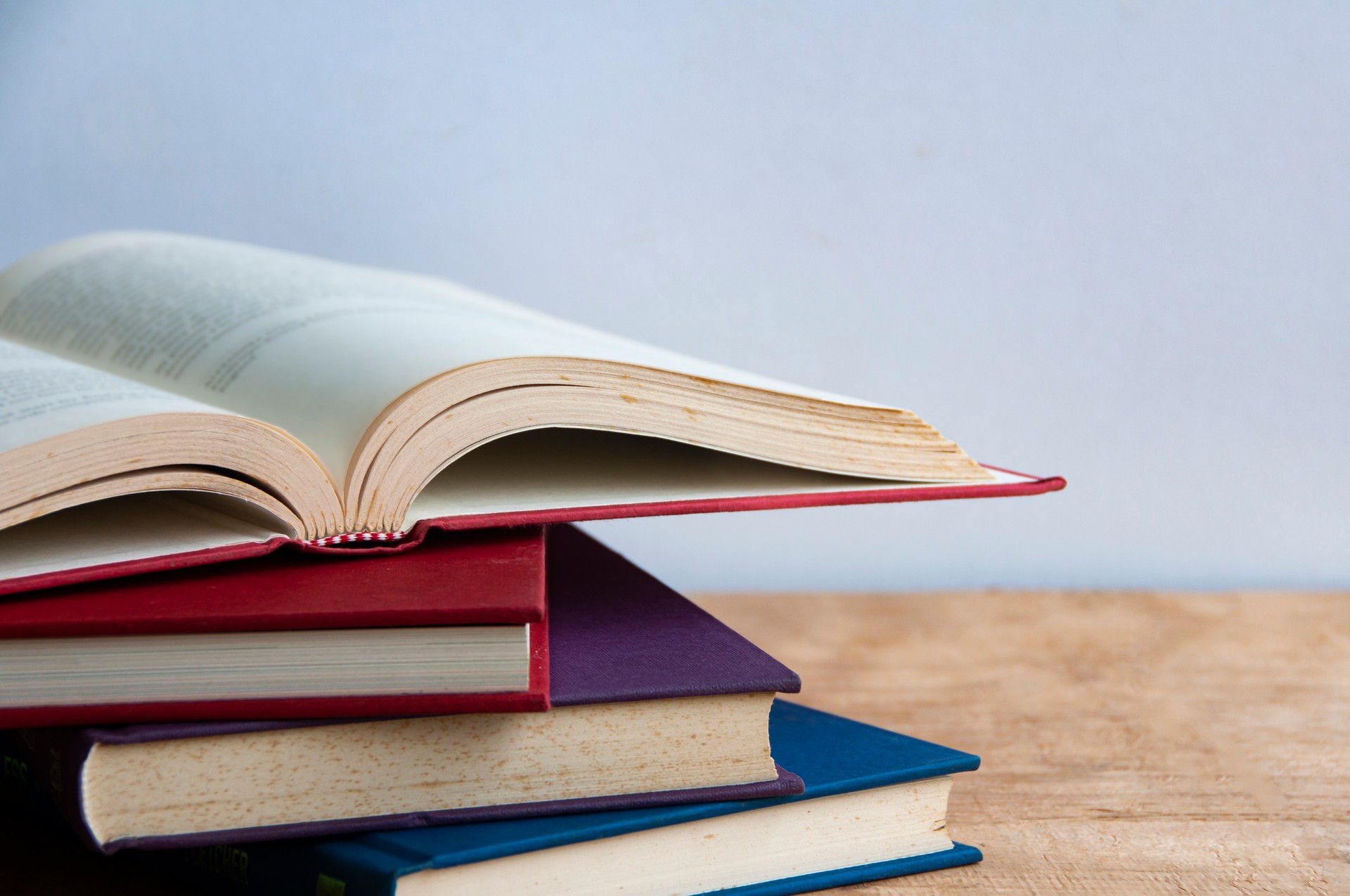 Books on wooden table with customizable space for text or ideas. Copy space and education concept.